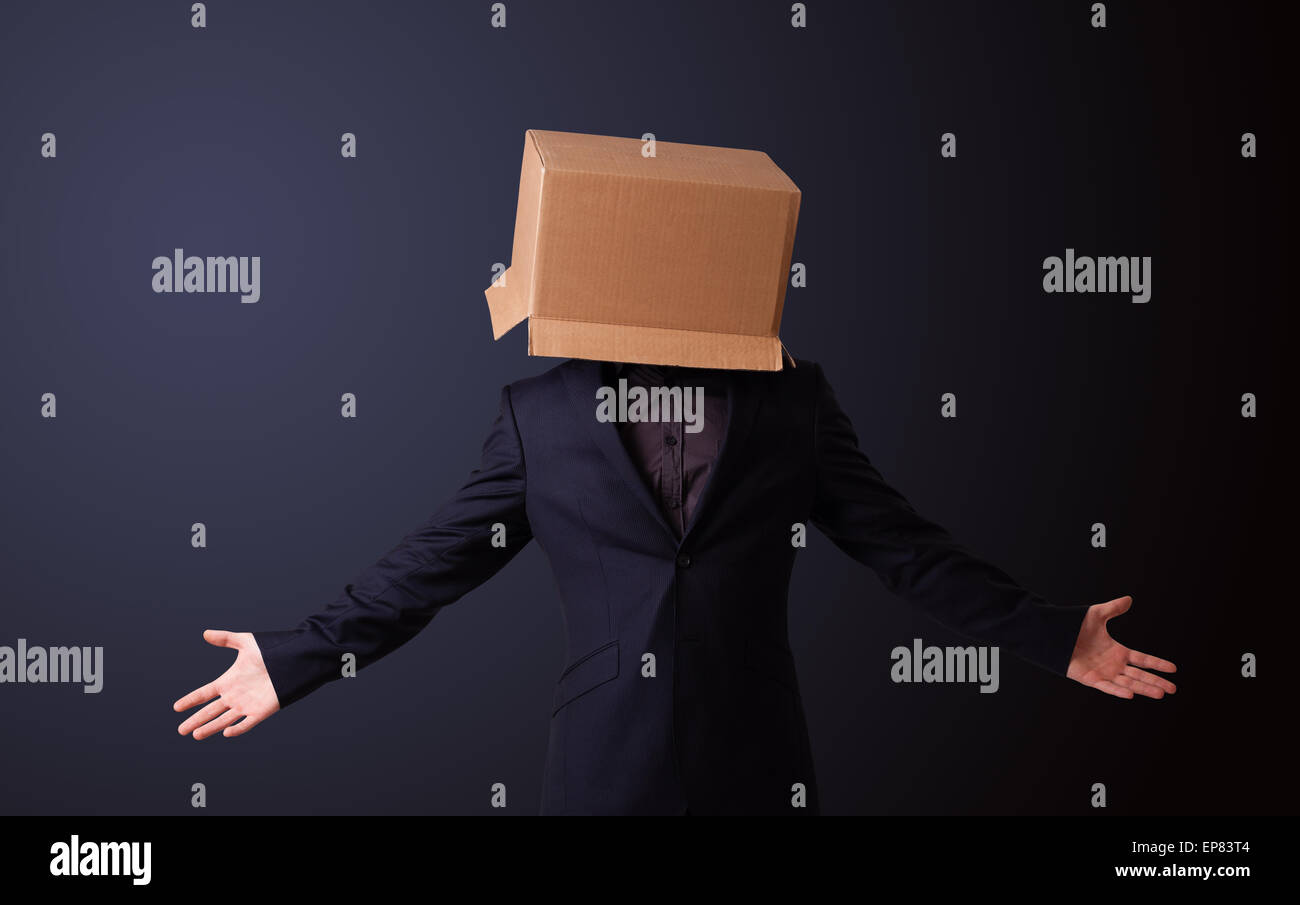 Young man gesturing with a cardboard box on his head Stock Photo - Alamy