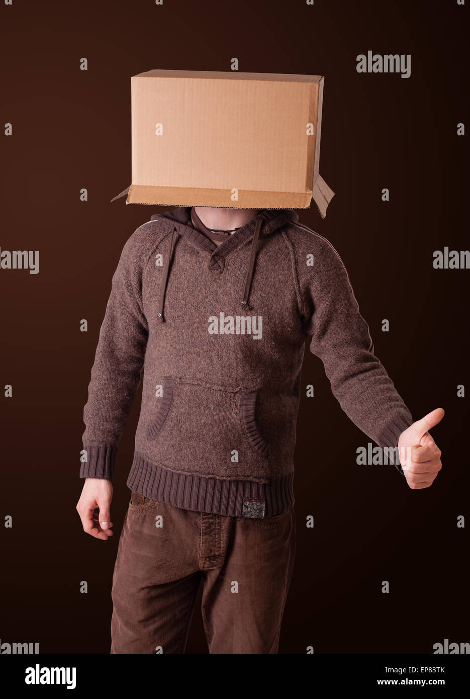 Young man gesturing with a cardboard box on his head Stock Photo - Alamy