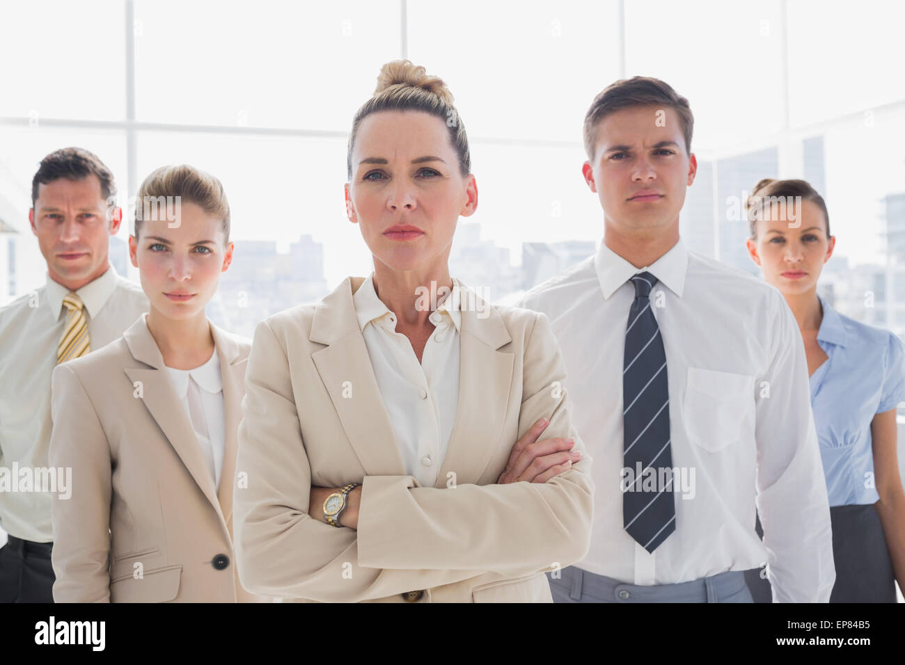 Group of serious business team standing together Stock Photo - Alamy