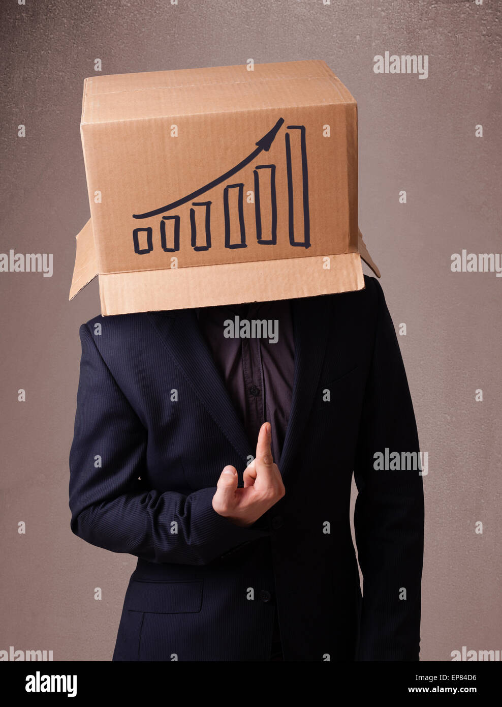 Young man gesturing with a cardboard box on his head with diagram Stock ...