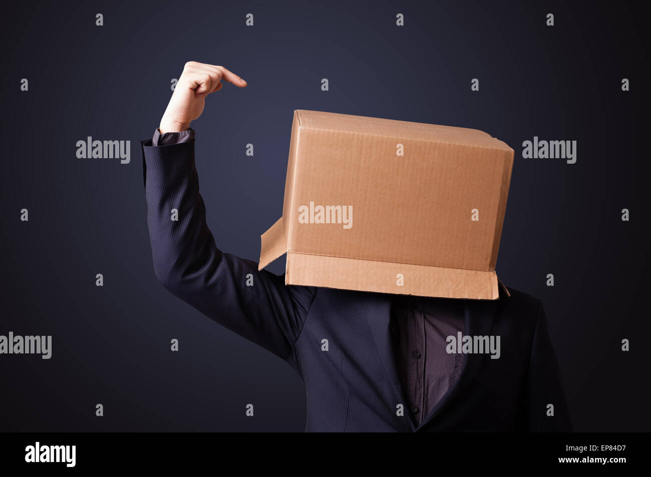 Young man gesturing with a cardboard box on his head Stock Photo