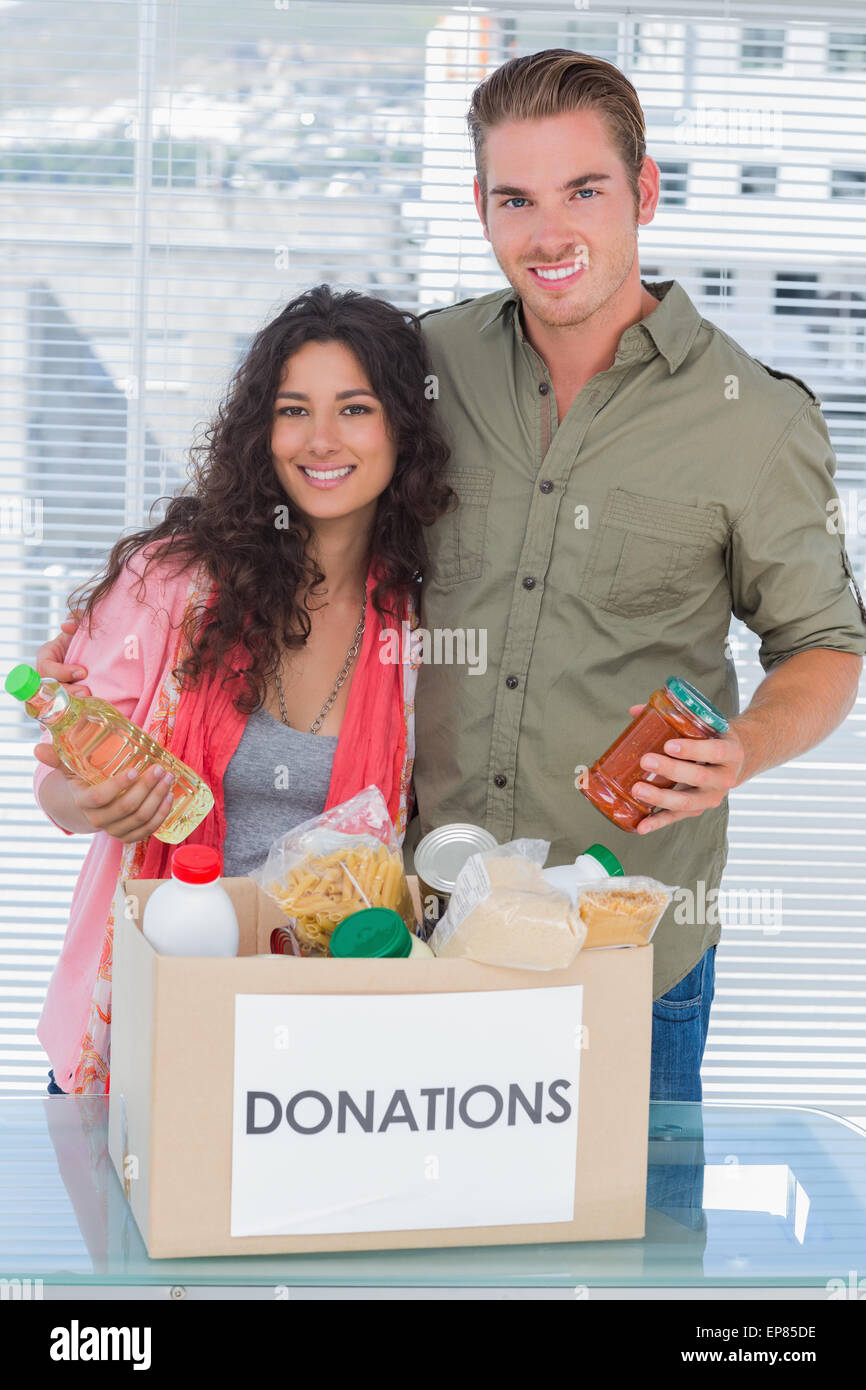 Close volunteers taking out food from donations box Stock Photo Alamy