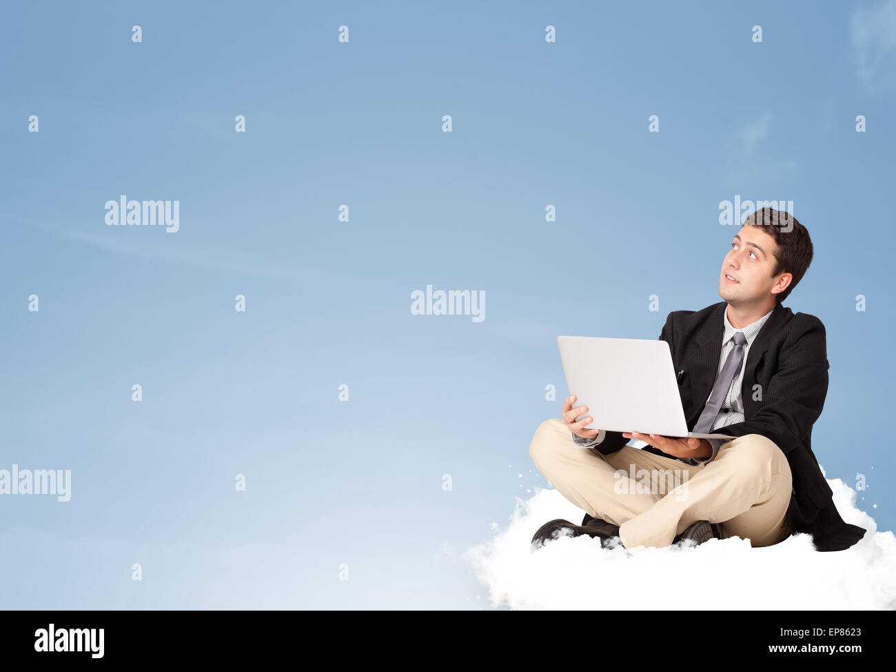 Attractive businessman sitting on cloud with copy space Stock Photo - Alamy