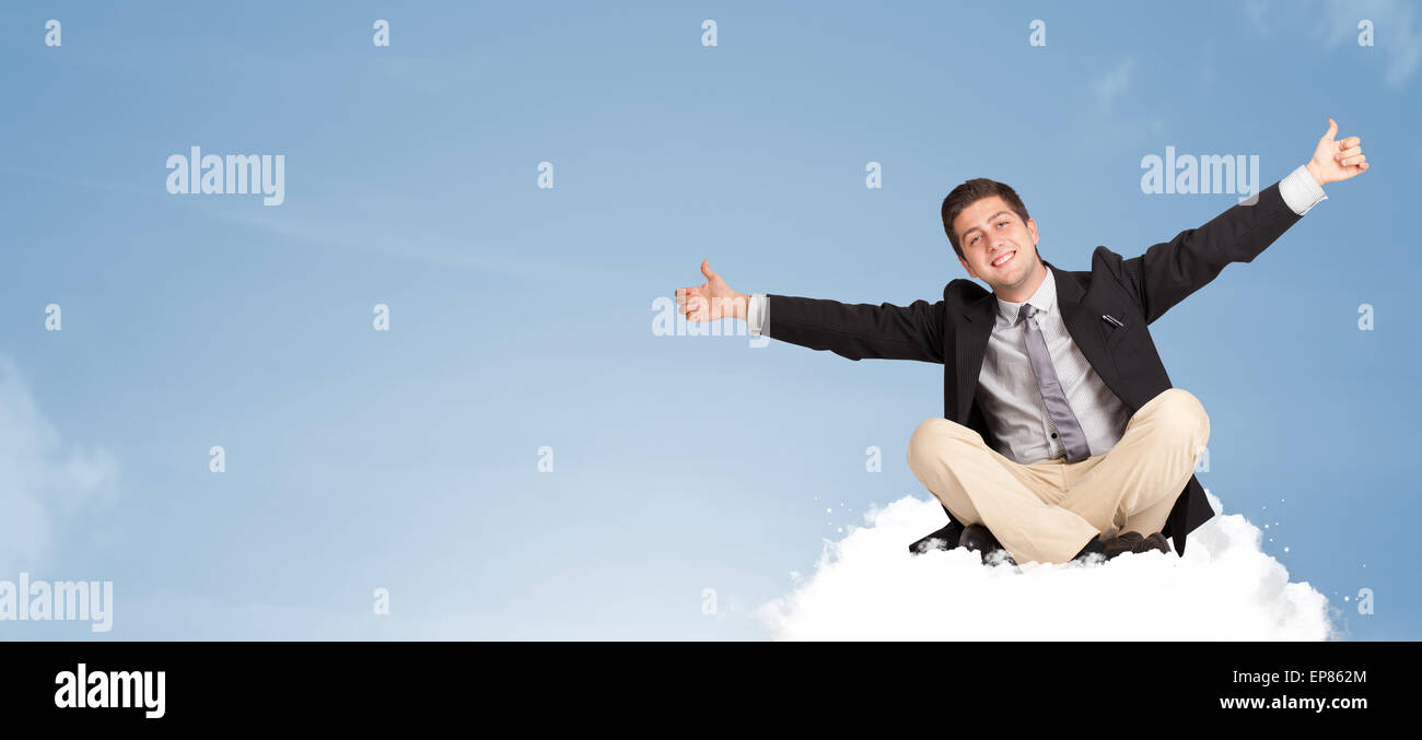 Attractive businessman sitting on cloud with copy space Stock Photo - Alamy