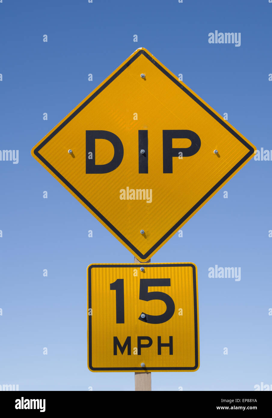 dip 15 mph road sign with blue sky background Stock Photo