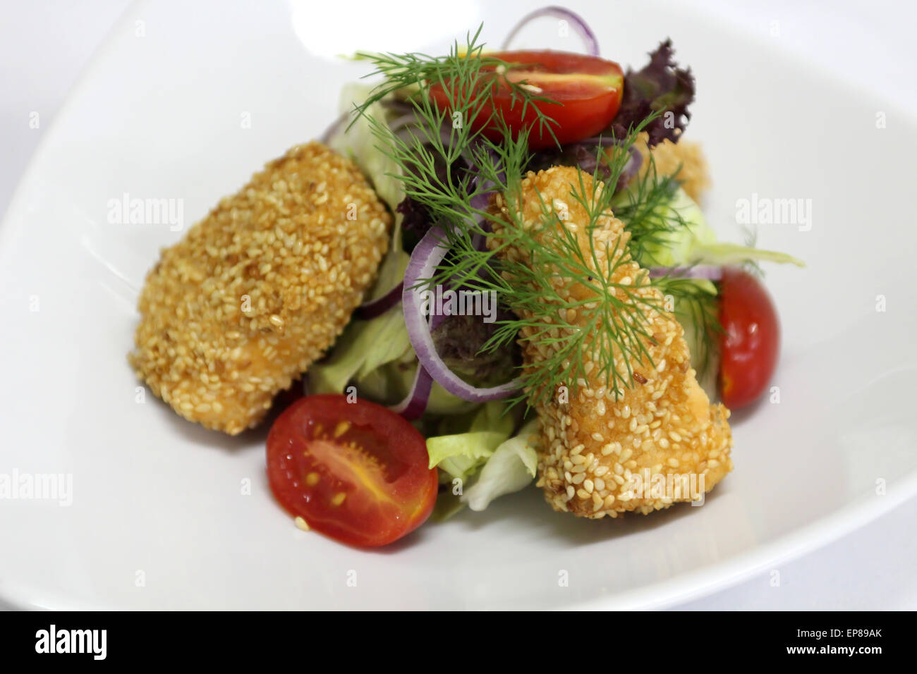 Delicious salad served in a white plate. Stock Photo