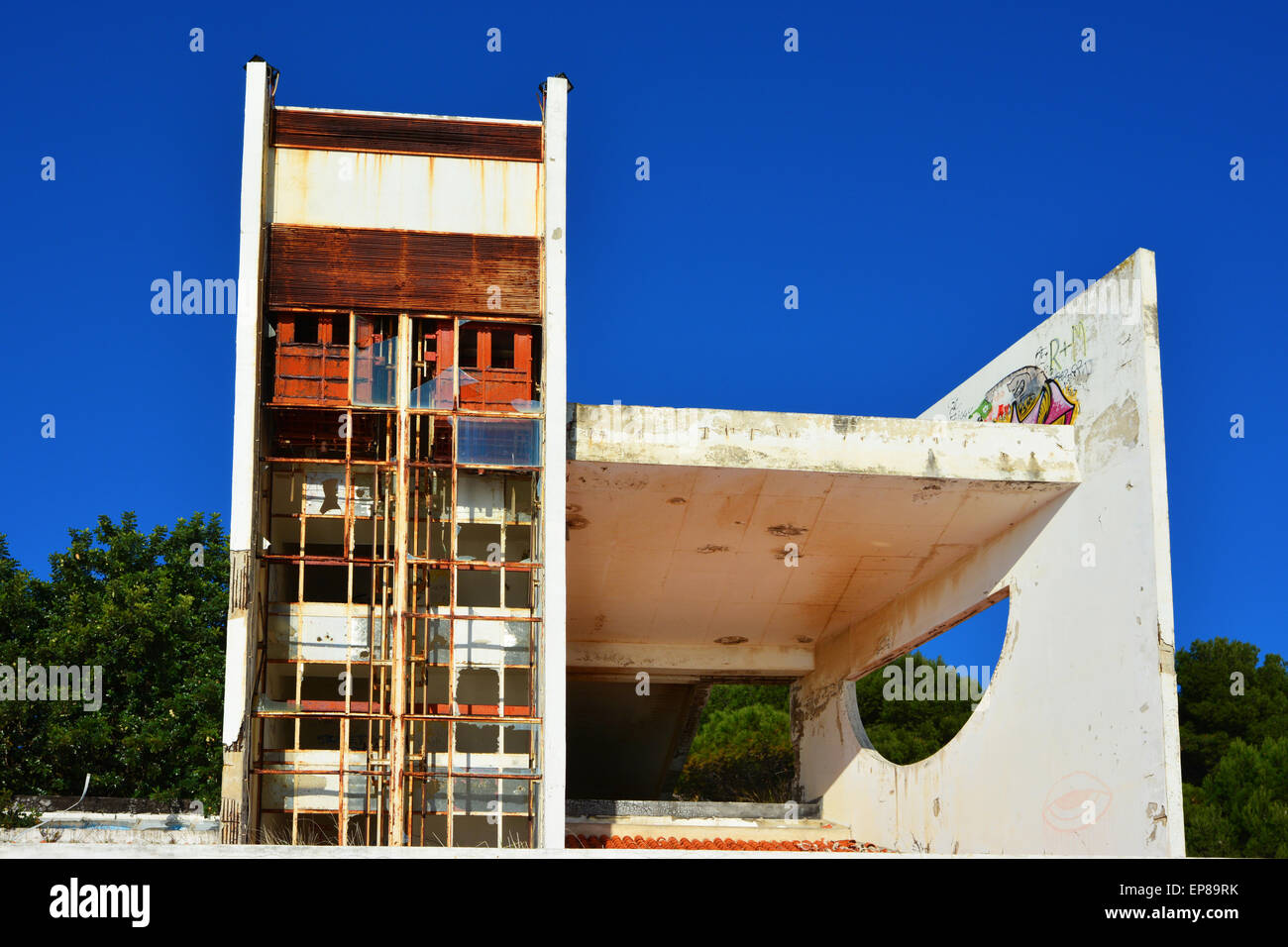Abandoned and damaged modern buildings against blue sky Stock Photo