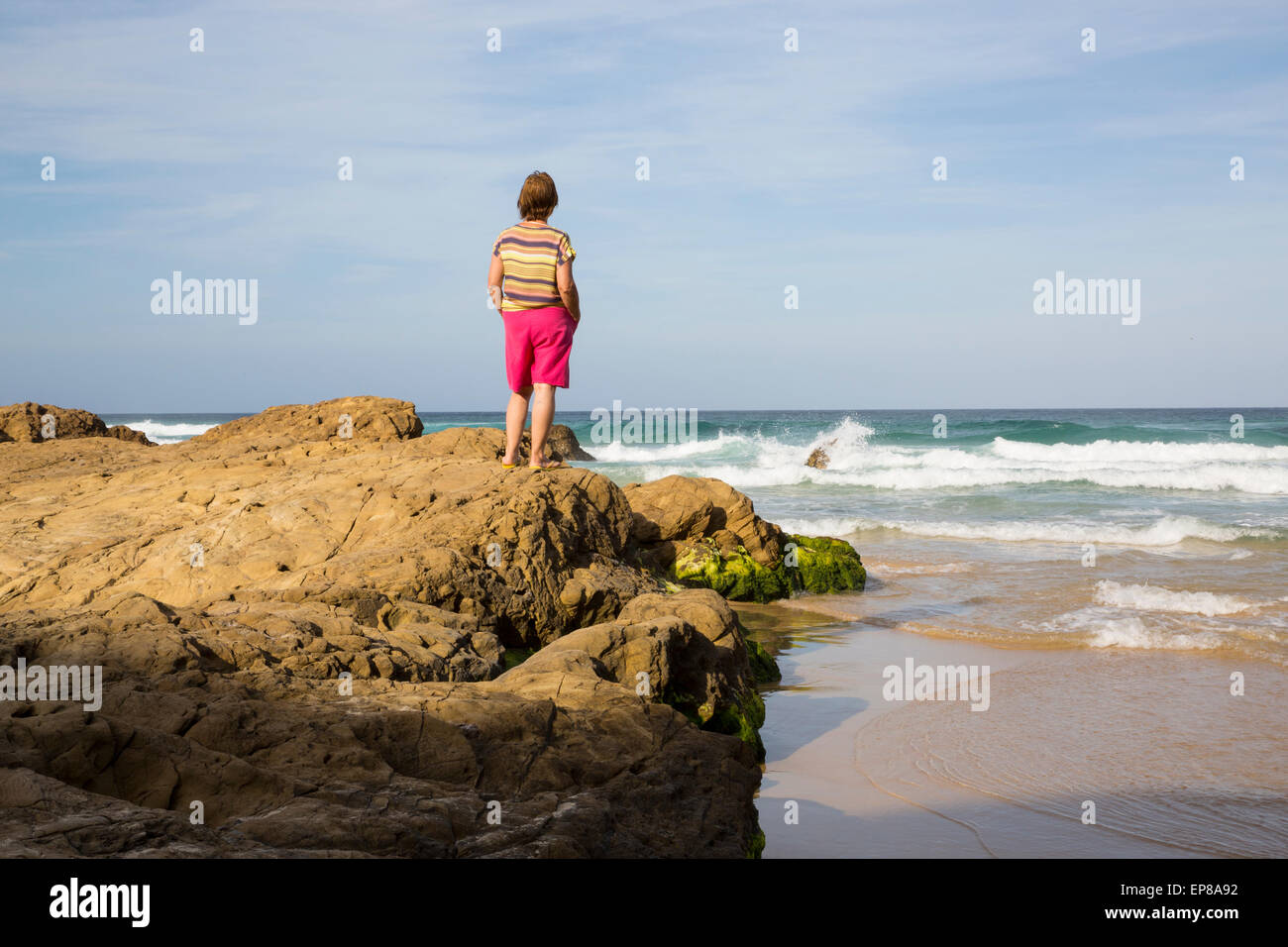 Lonely woman at the beach Stock Photo