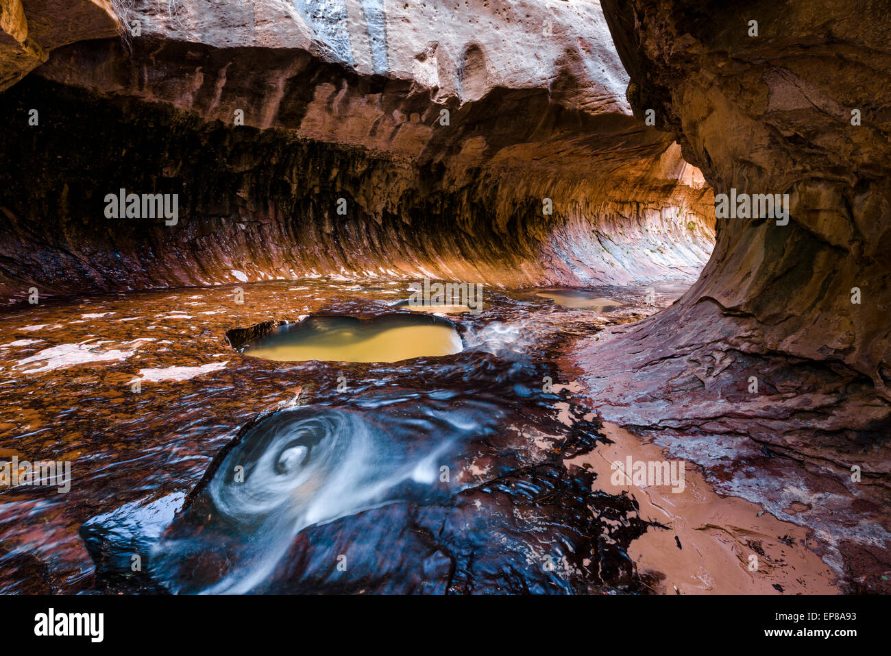 Water swirls inside the lava tube of the Subway at Zion national park