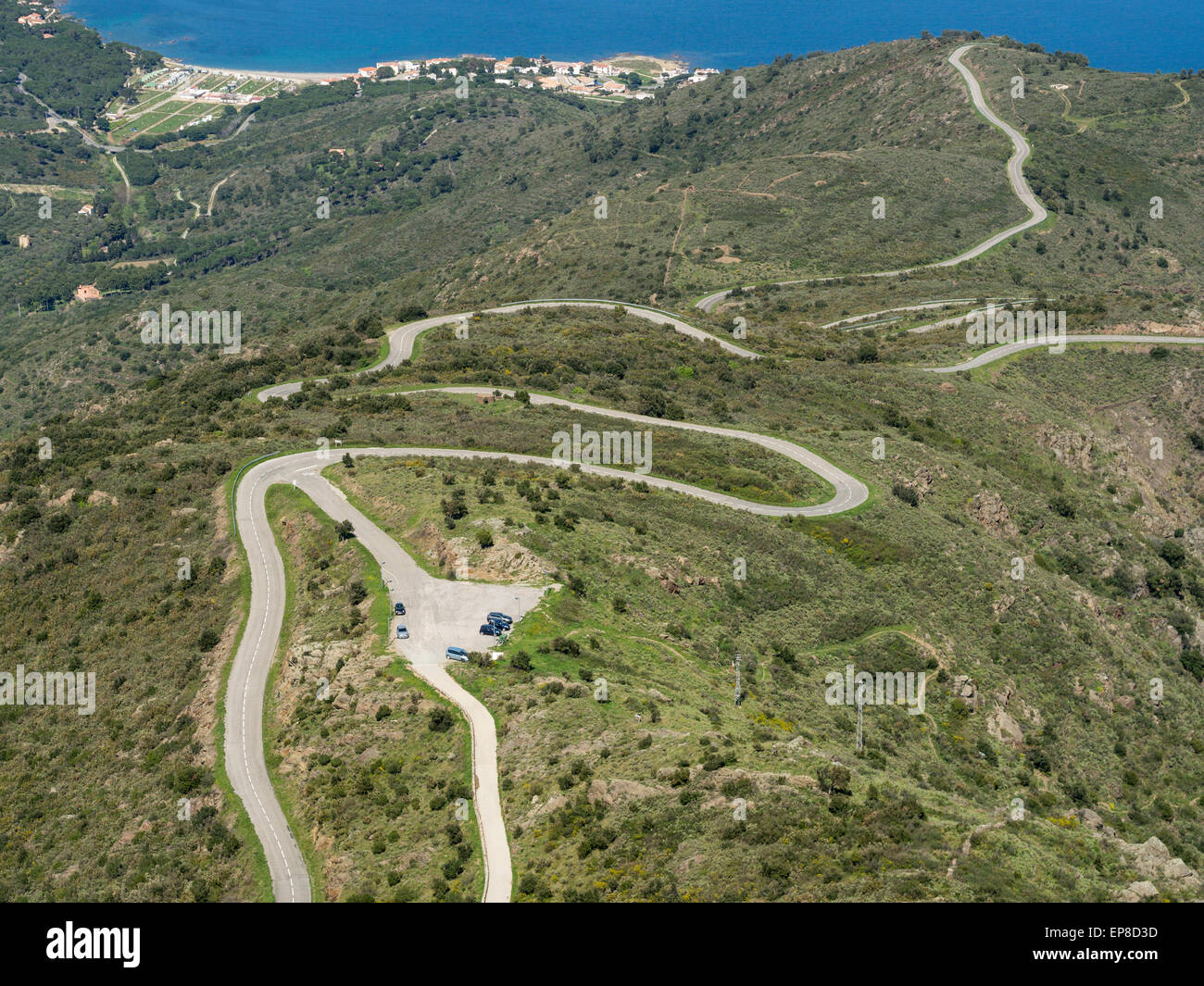 Twisting Road to Rodes. The winding road that climbs the steep hills above the blue Mediterranean Sea to the abbey parking lot Stock Photo