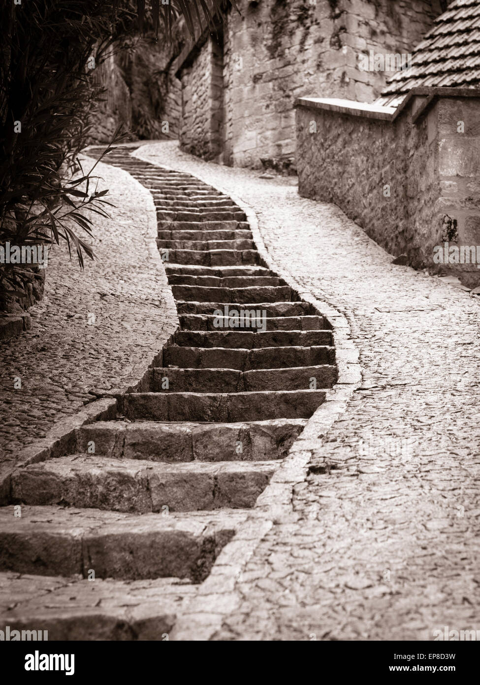 Winding stairs up La Roche, monochrome. Stone stairs make it easier to navigate the steep lanes in this cliff-side village. Stock Photo
