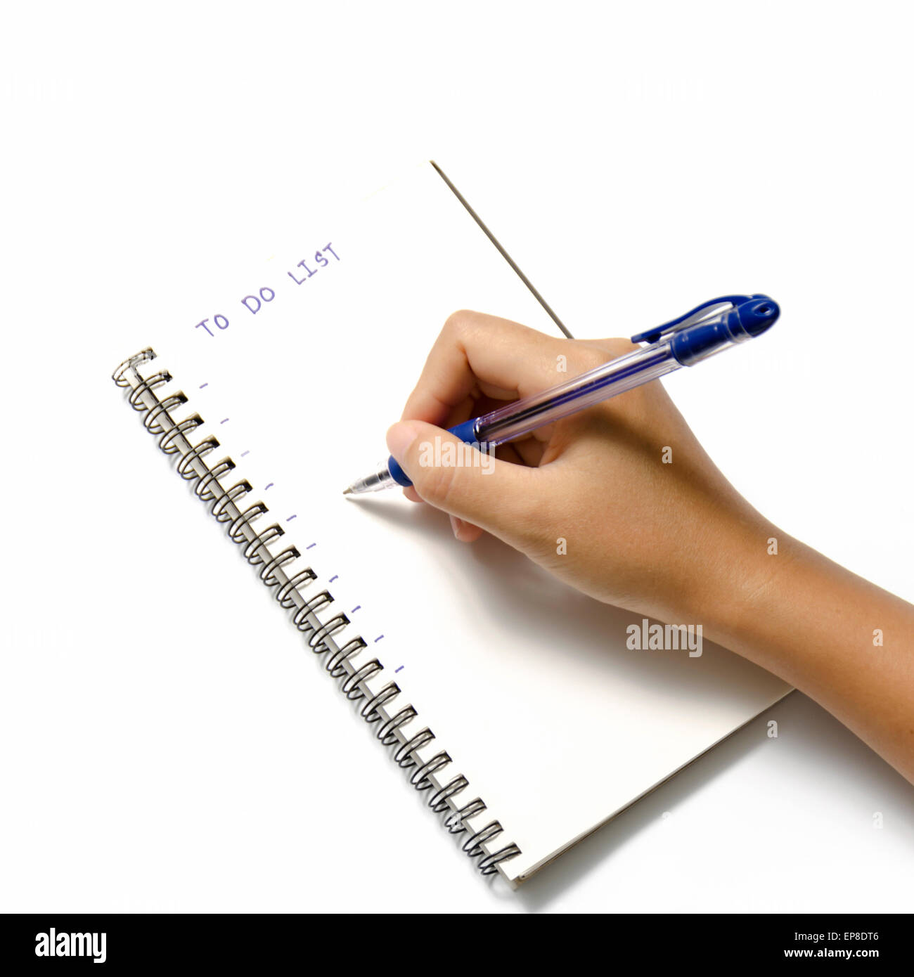 woman hand writing with pen on notebook write to do word over white background Stock Photo