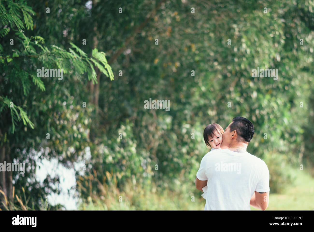 A father with adorable daughter walking in the park Stock Photo - Alamy