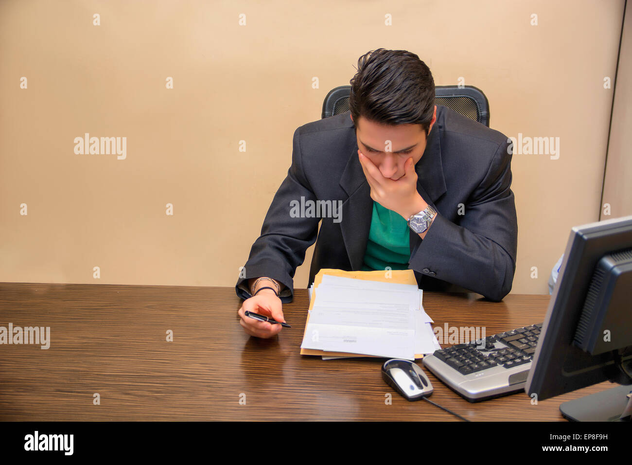 Preoccupied, worried, desperate young male worker staring at computer ...