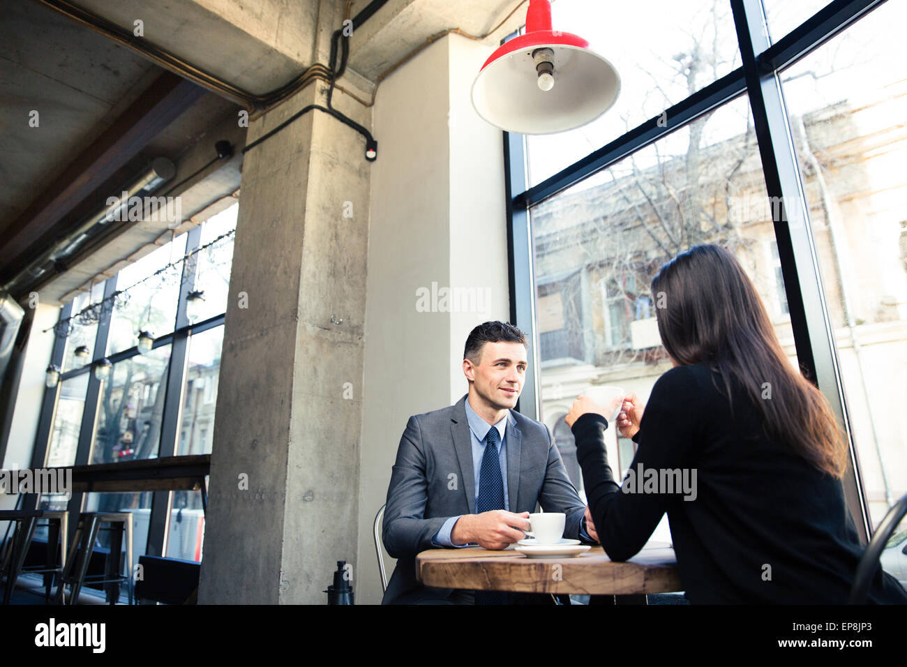 Businesswoman and happy businessman drinking coffee in cafe Stock Photo