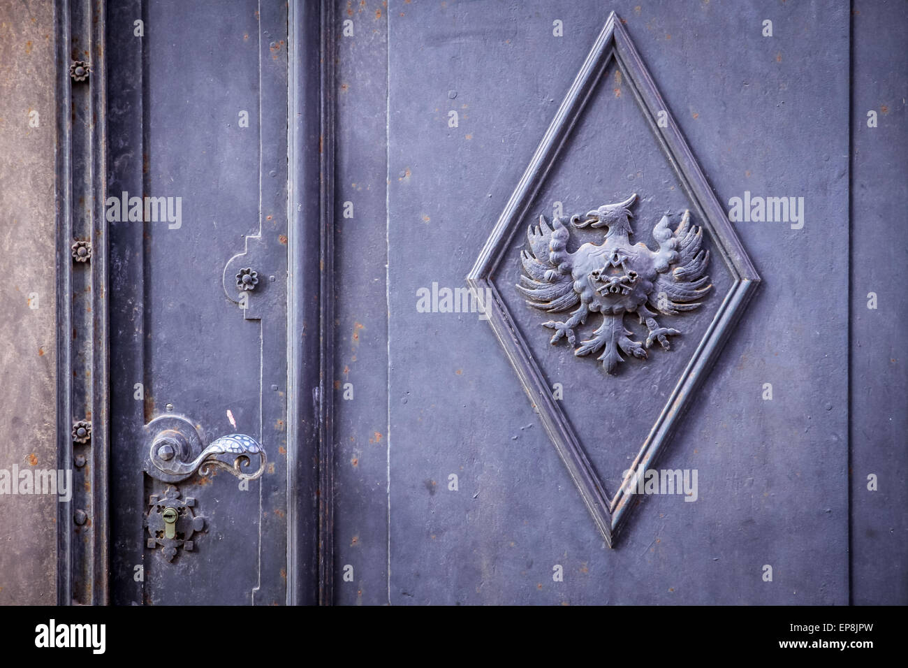 Massive old iron door with eagle and craftsmen icon Stock Photo