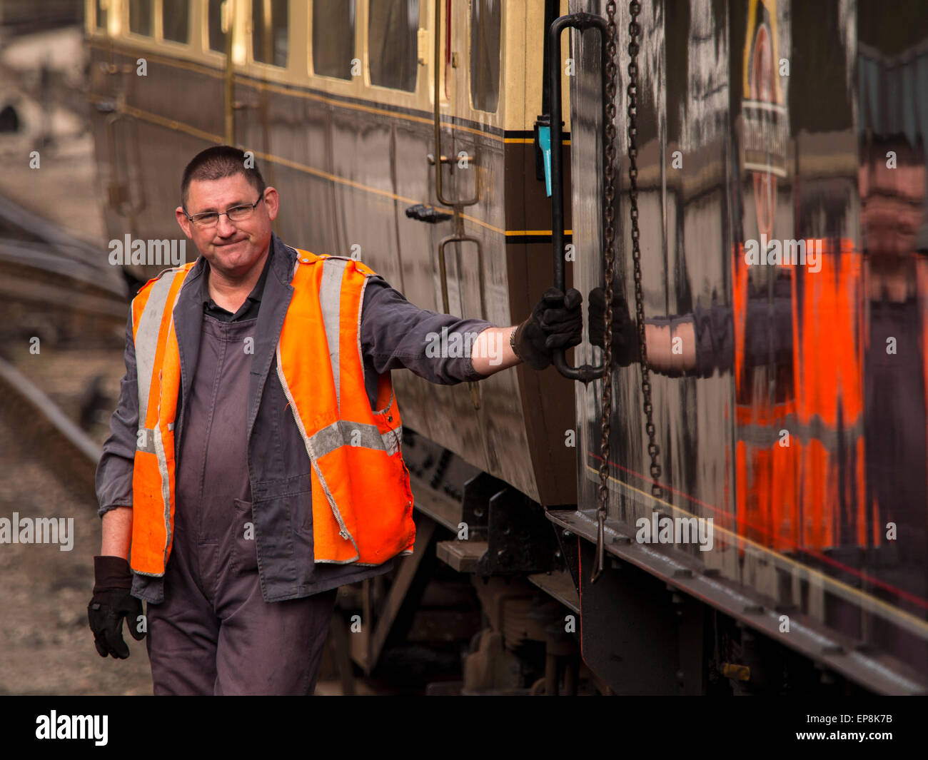train driver climbs on board steam at Grosmont station,on