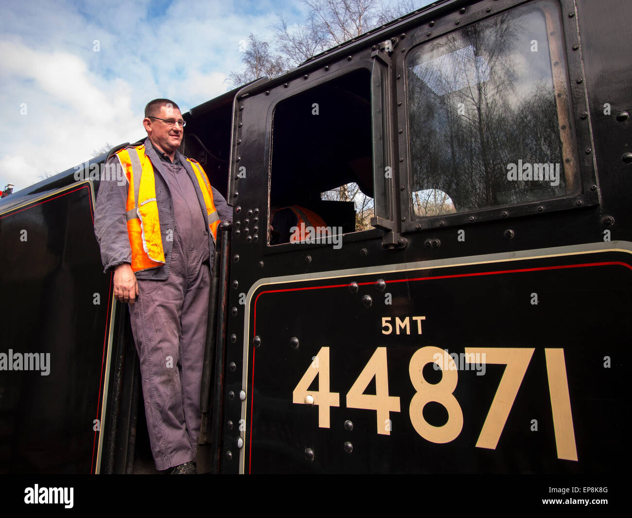 train driver climbs on board steam at Grosmont station,on