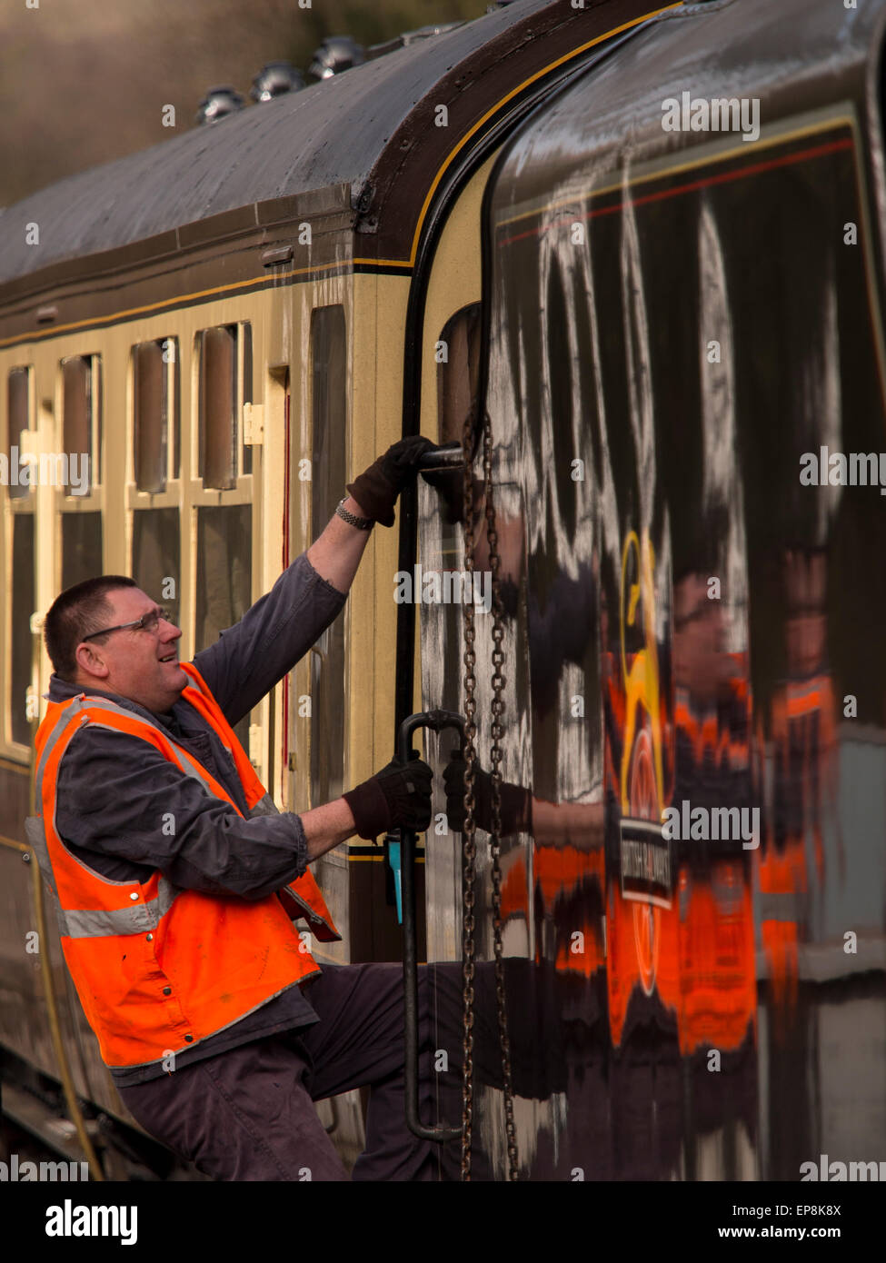 train driver climbs on board steam at Grosmont station,on