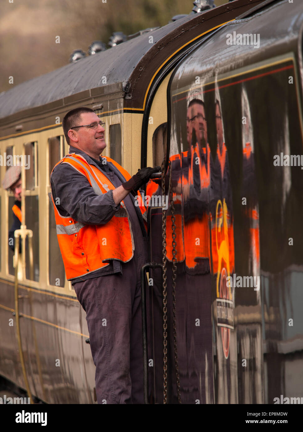 train driver climbs on board steam at Grosmont station,on