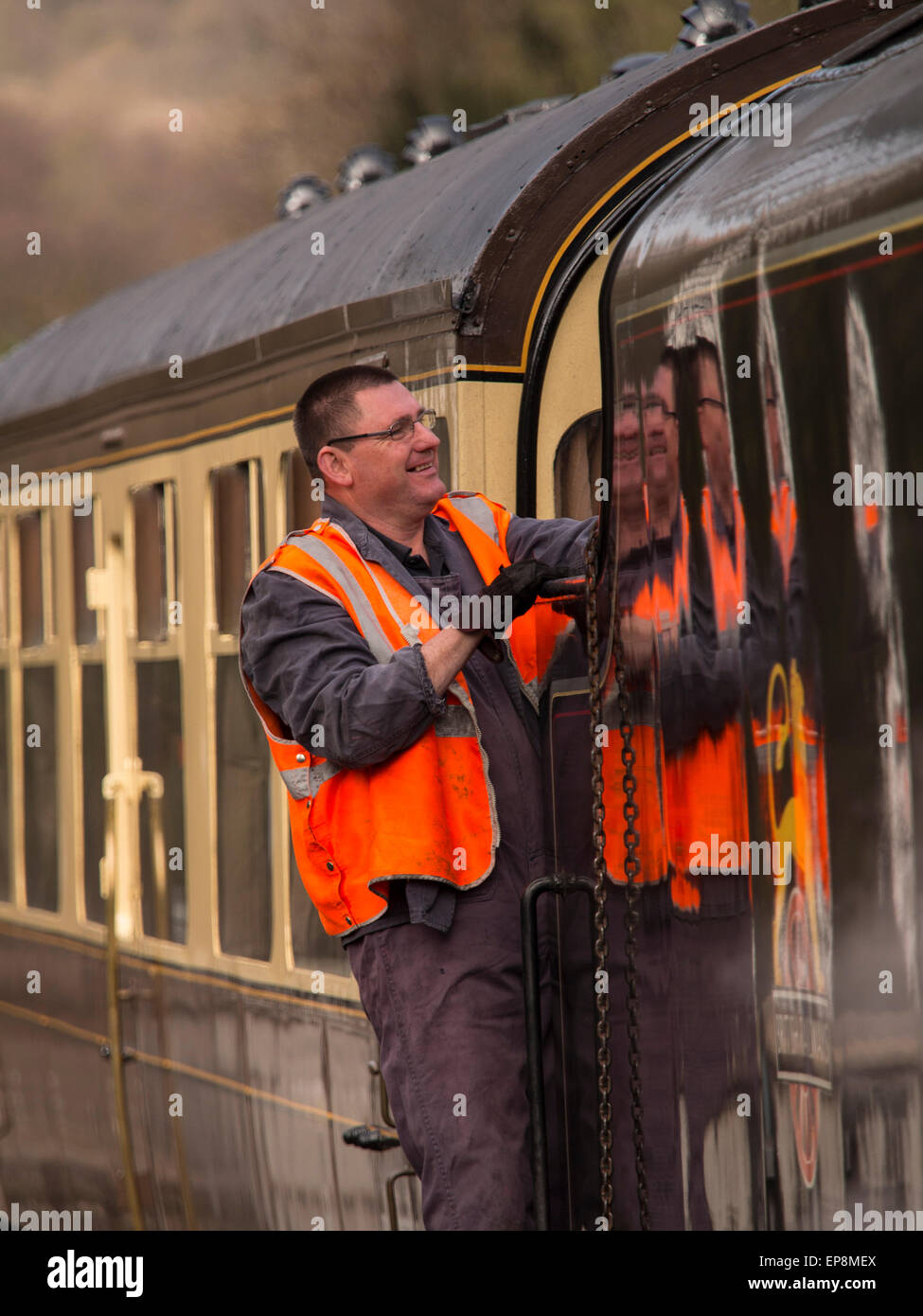 train driver climbs on board steam at Grosmont station,on