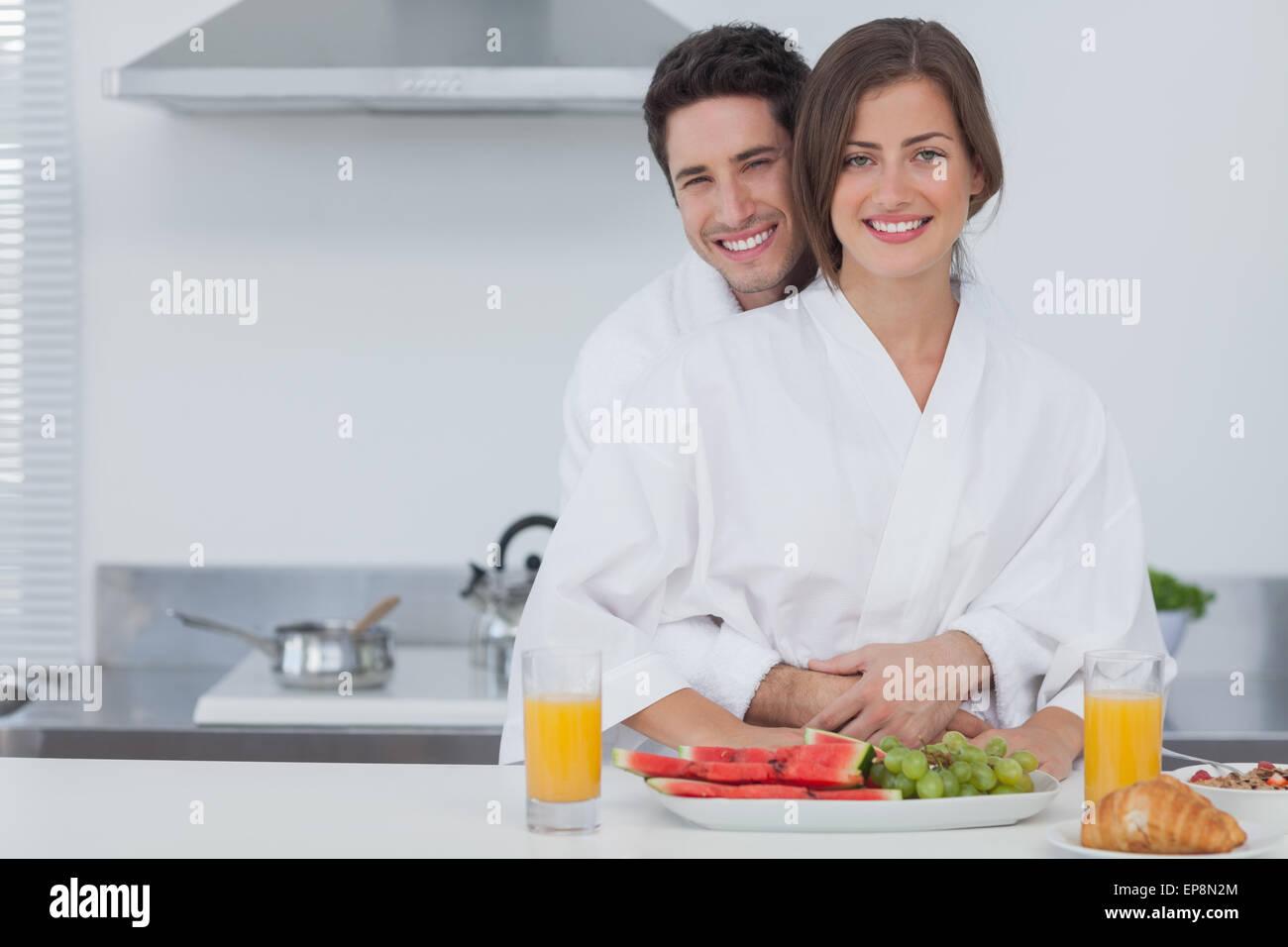 Portrait of a man embracing his wife in the kitchen Stock Photo - Alamy