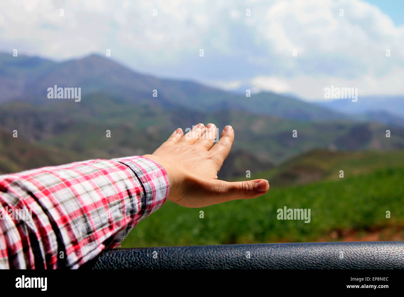hand out of a car in traveling in nature Stock Photo