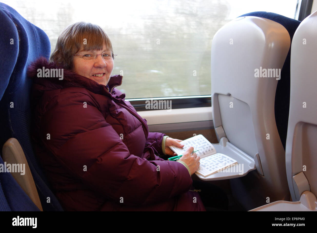Passenger on Train doing Crossword Puzzle Stock Photo Alamy