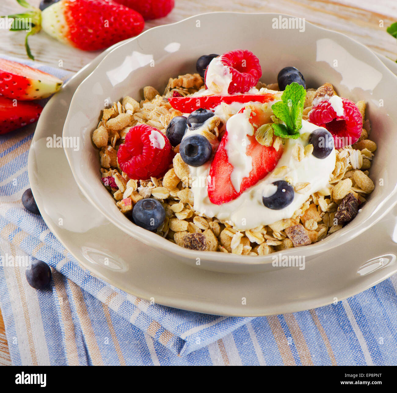 Breakfast with fresh berries, yogurt and  muesli. Selective focus Stock Photo
