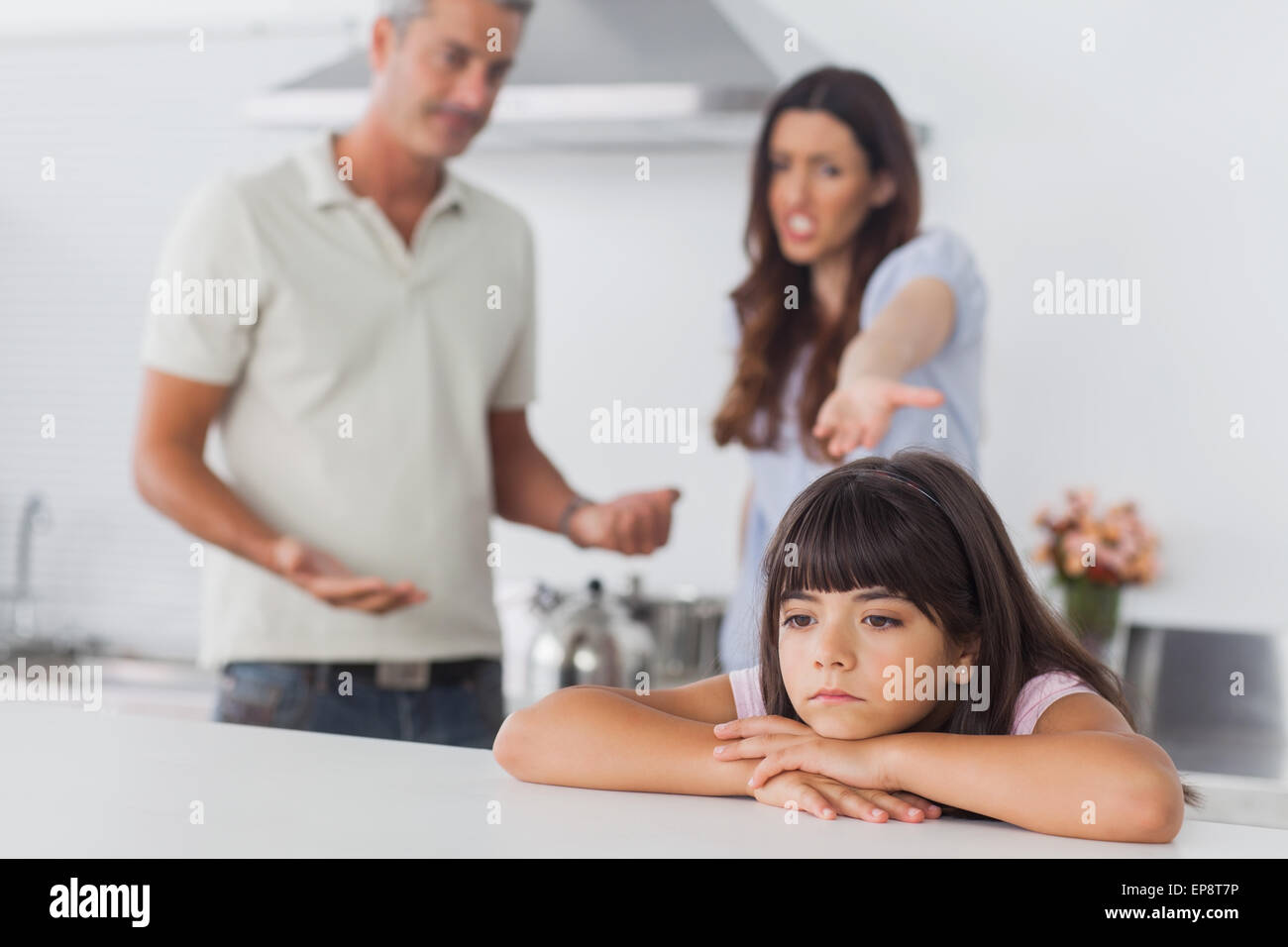 Couple having dispute in front of their upset daughter Stock Photo