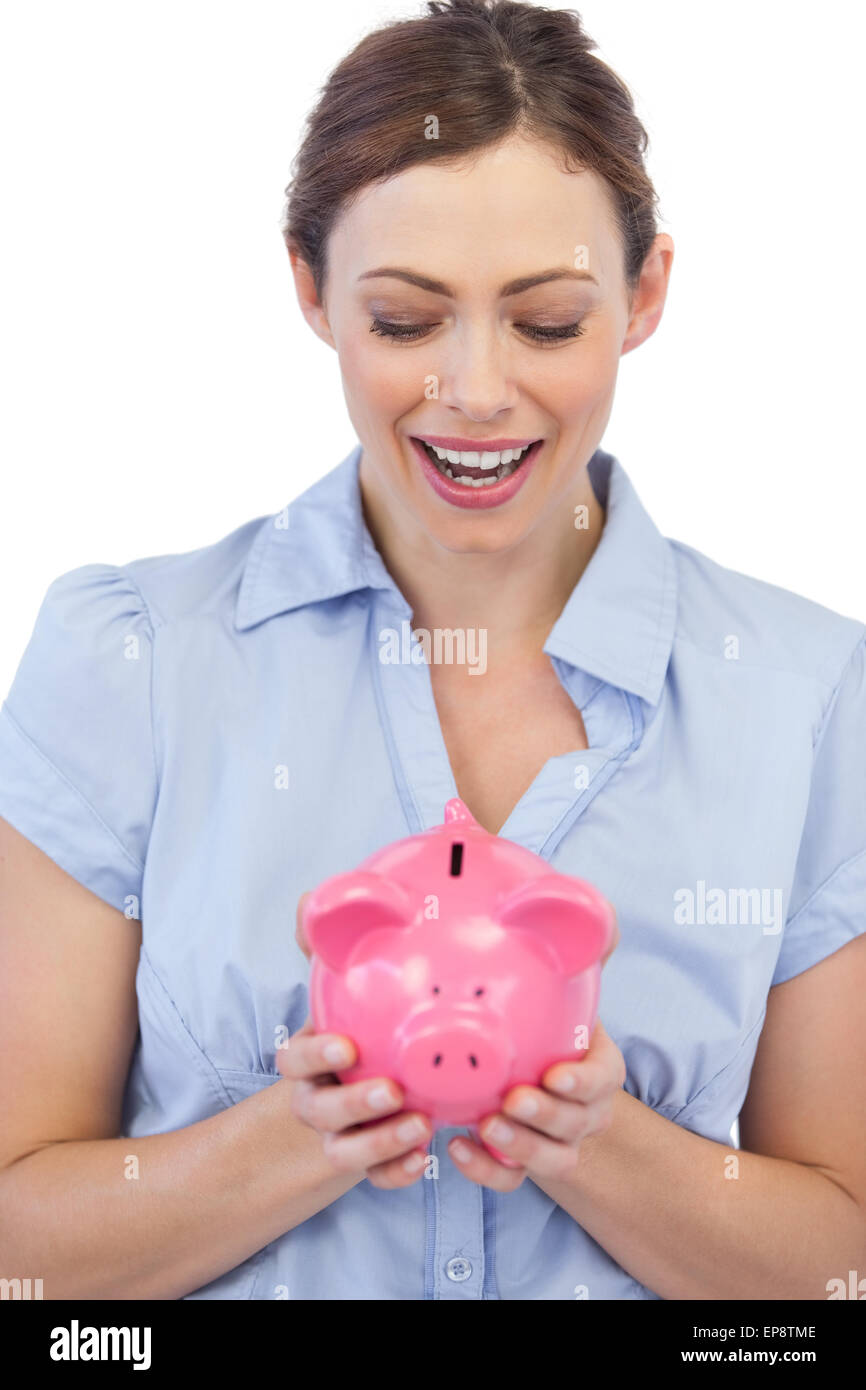 Astonished businesswoman posing with piggy bank Stock Photo - Alamy