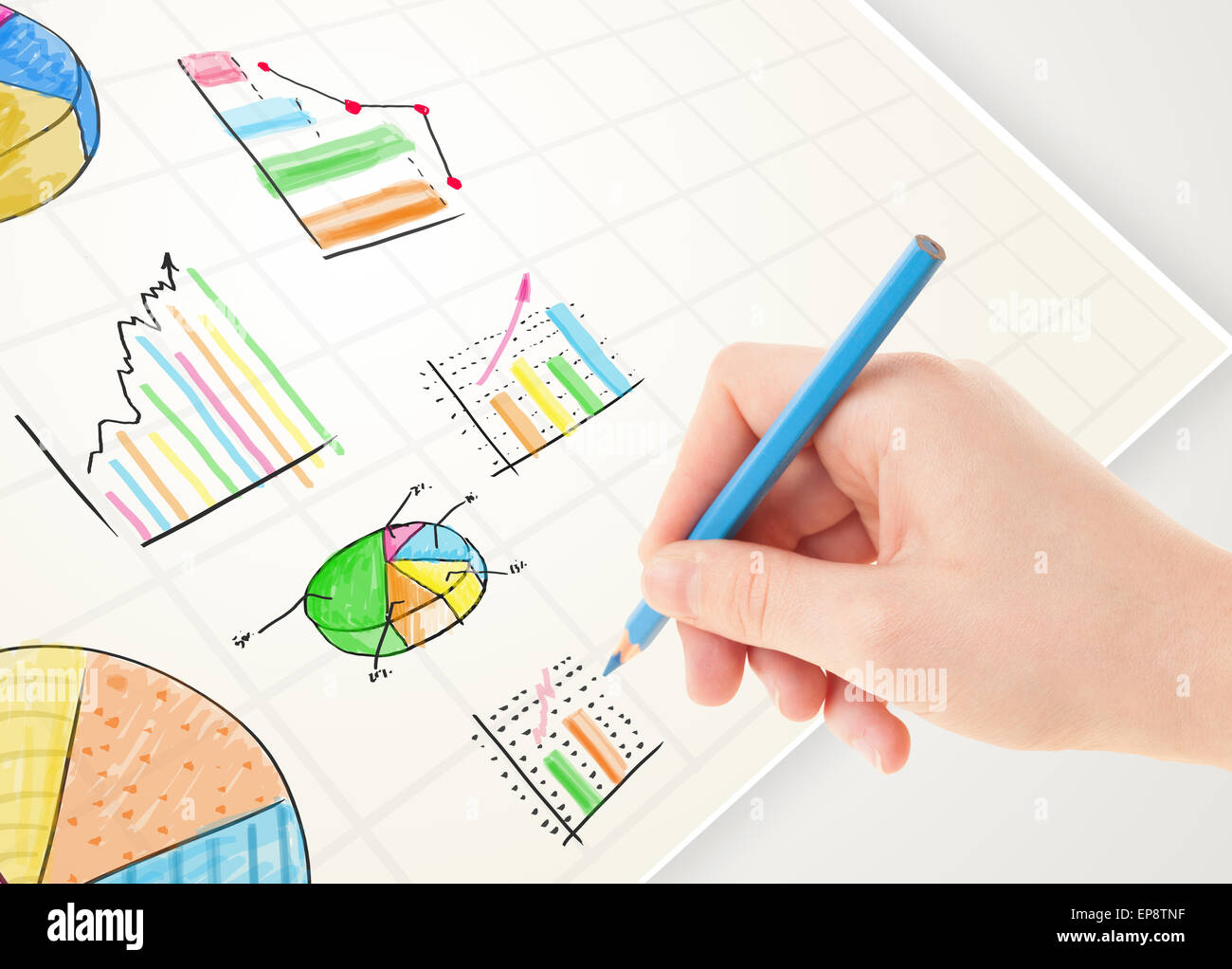 Business person drawing colorful graphs and icons on paper Stock Photo ...