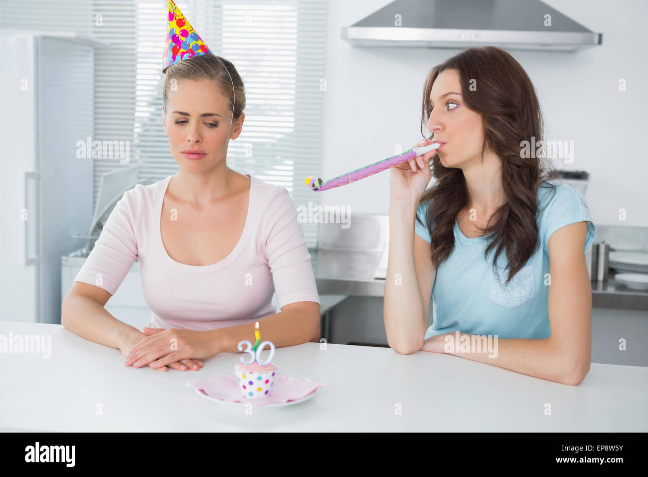 Woman cheering up her upset friend on her 30th birthday Stock Photo Alamy