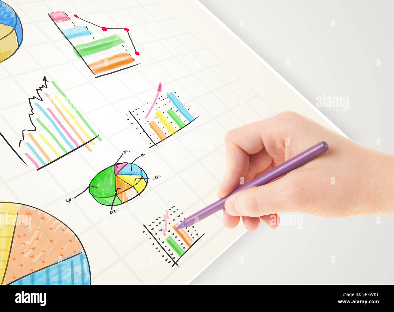 Business person drawing colorful graphs and icons on paper Stock Photo ...