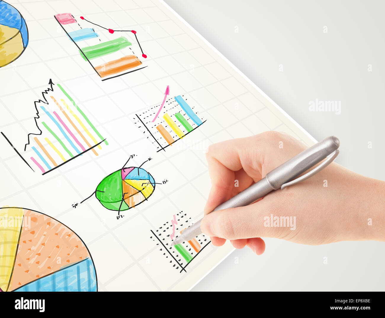 Business person drawing colorful graphs and icons on paper Stock Photo ...