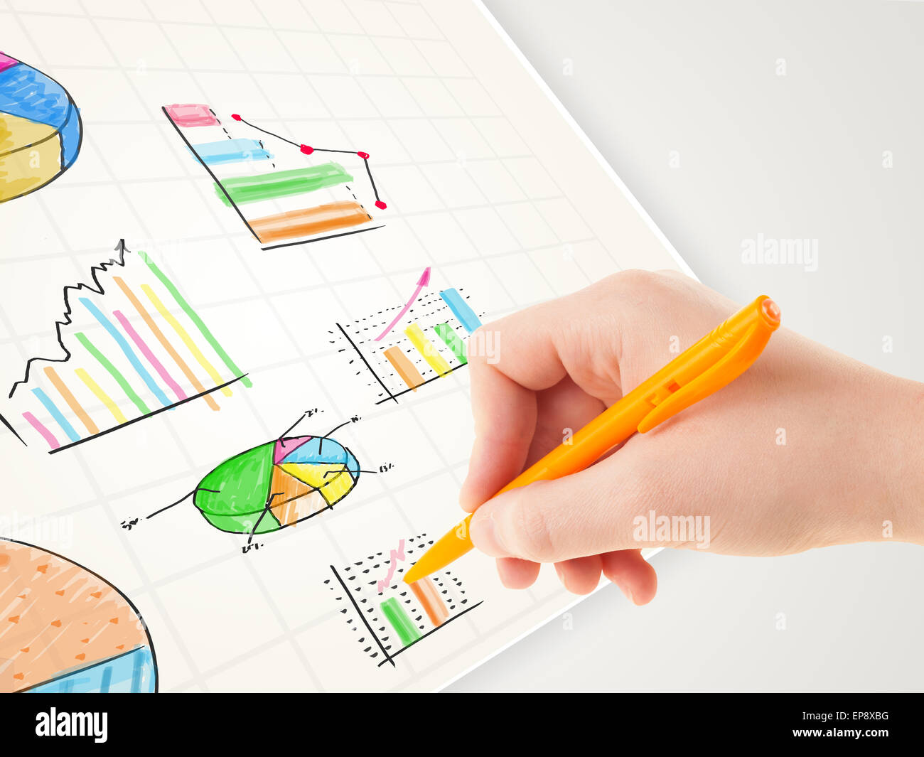 Business person drawing colorful graphs and icons on paper Stock Photo ...