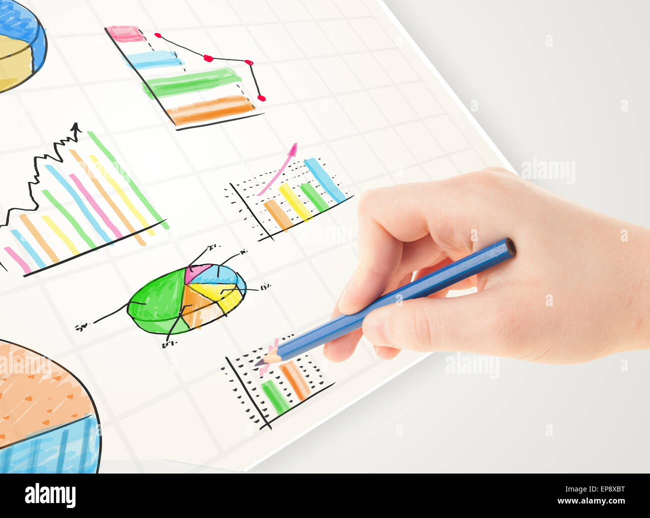Business person drawing colorful graphs and icons on paper Stock Photo ...