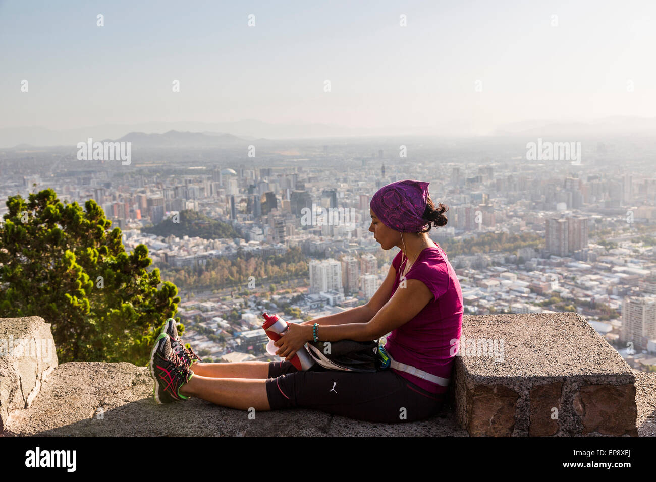 sportswoman relaxing with view of Santiago, Chile, from Terraza Bellavista, Parque Metropolitano de Santiago Stock Photo