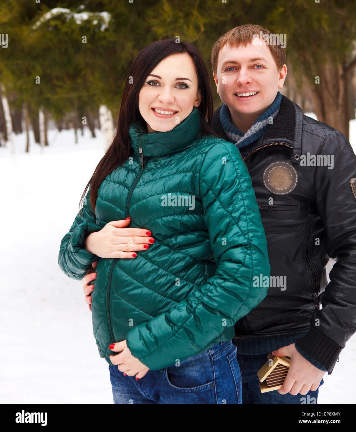 Happy young couple having fun in the winter park Stock Photo - Alamy