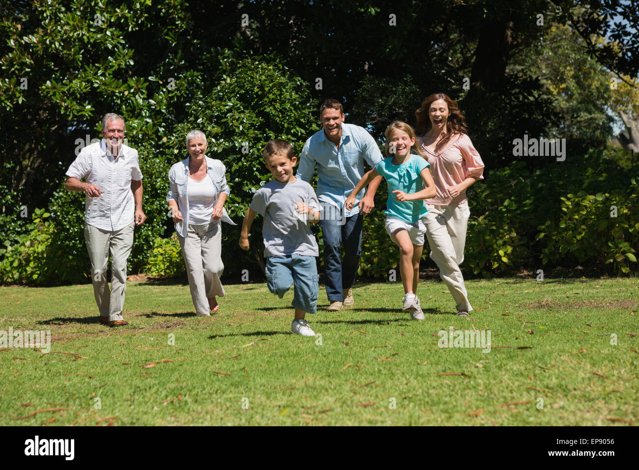 Happy multi generation family running towards camera Stock Photo - Alamy