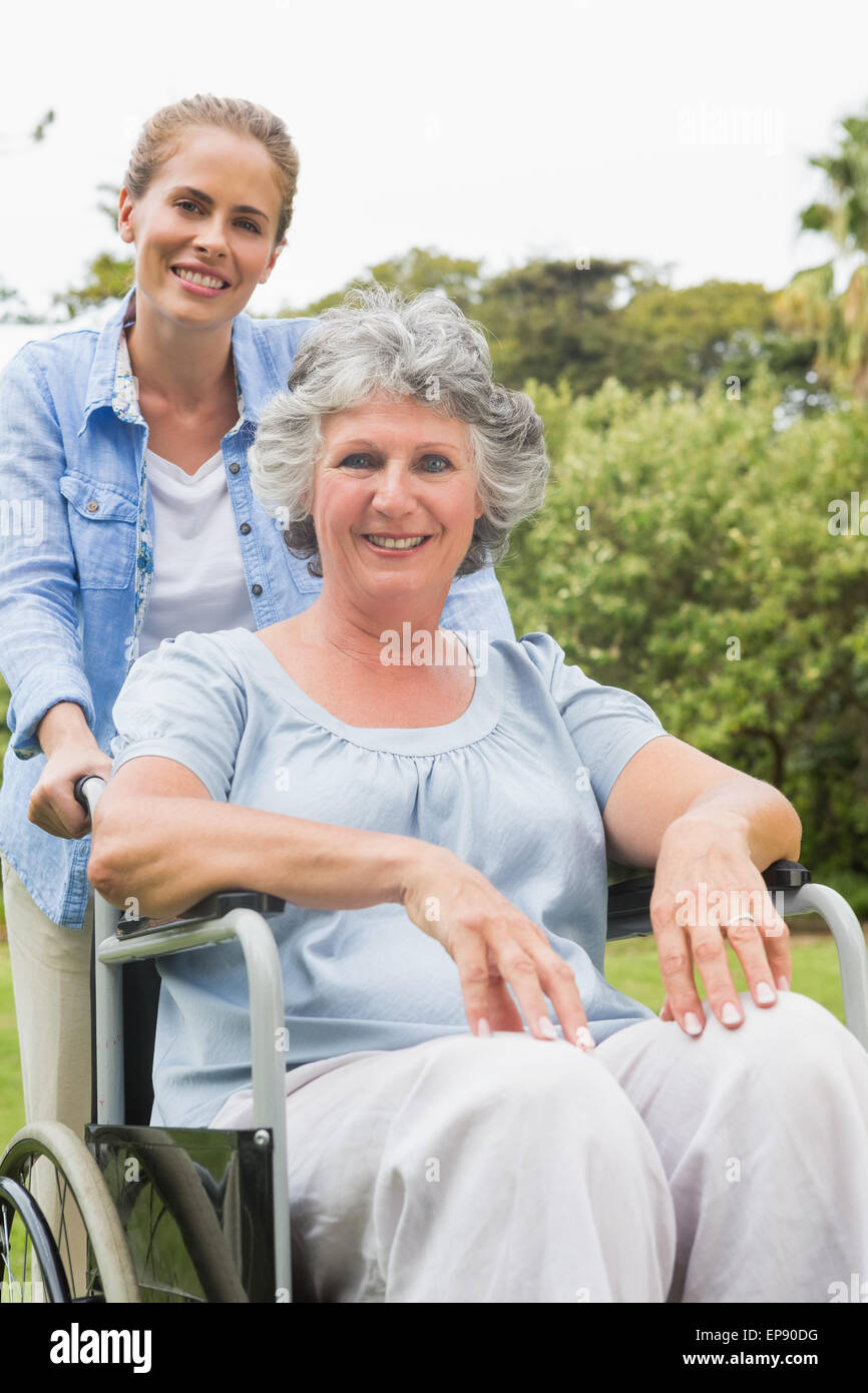 Smiling woman in wheelchair with her daughter Stock Photo - Alamy