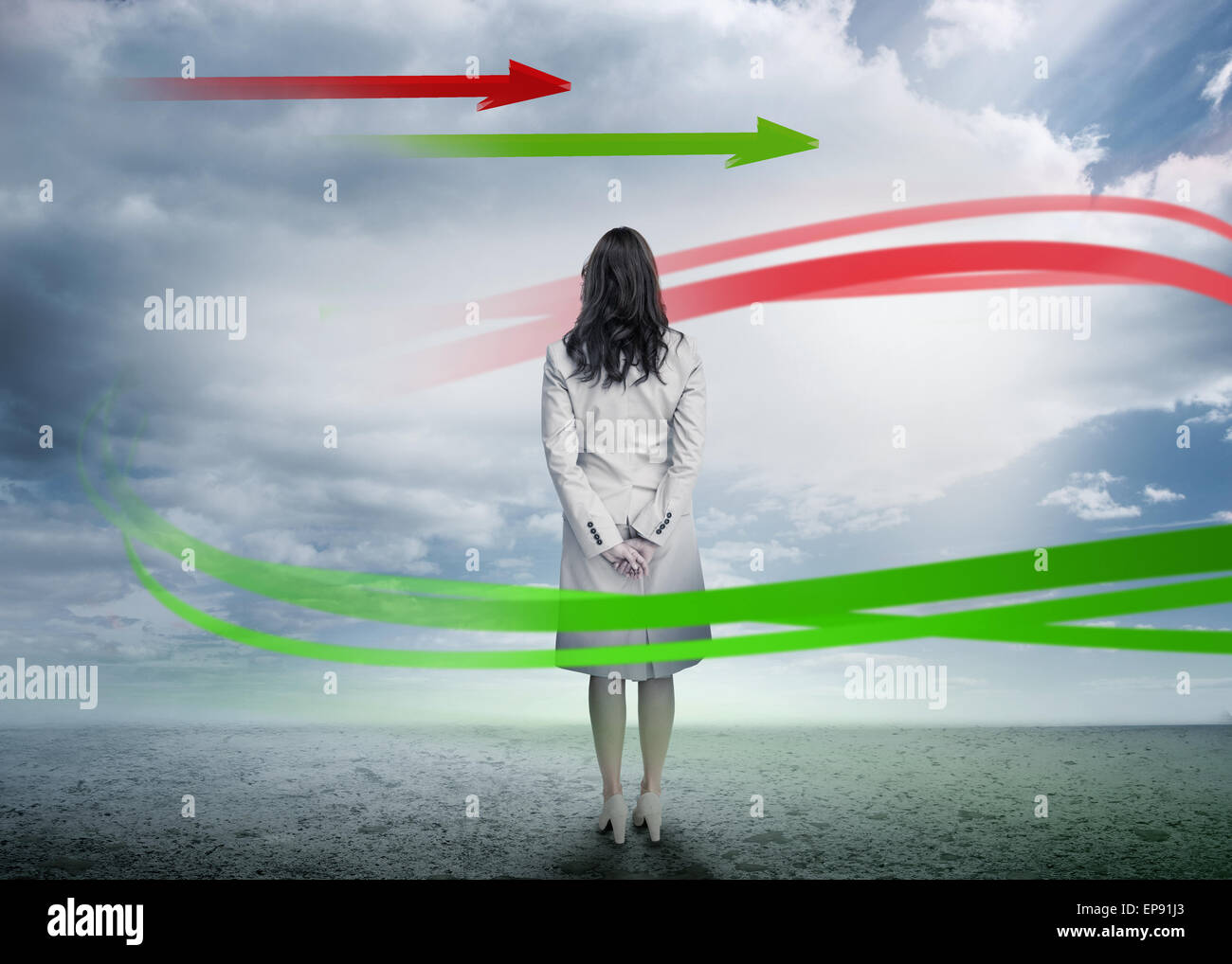 Businesswoman looking at red and green arrows Stock Photo - Alamy