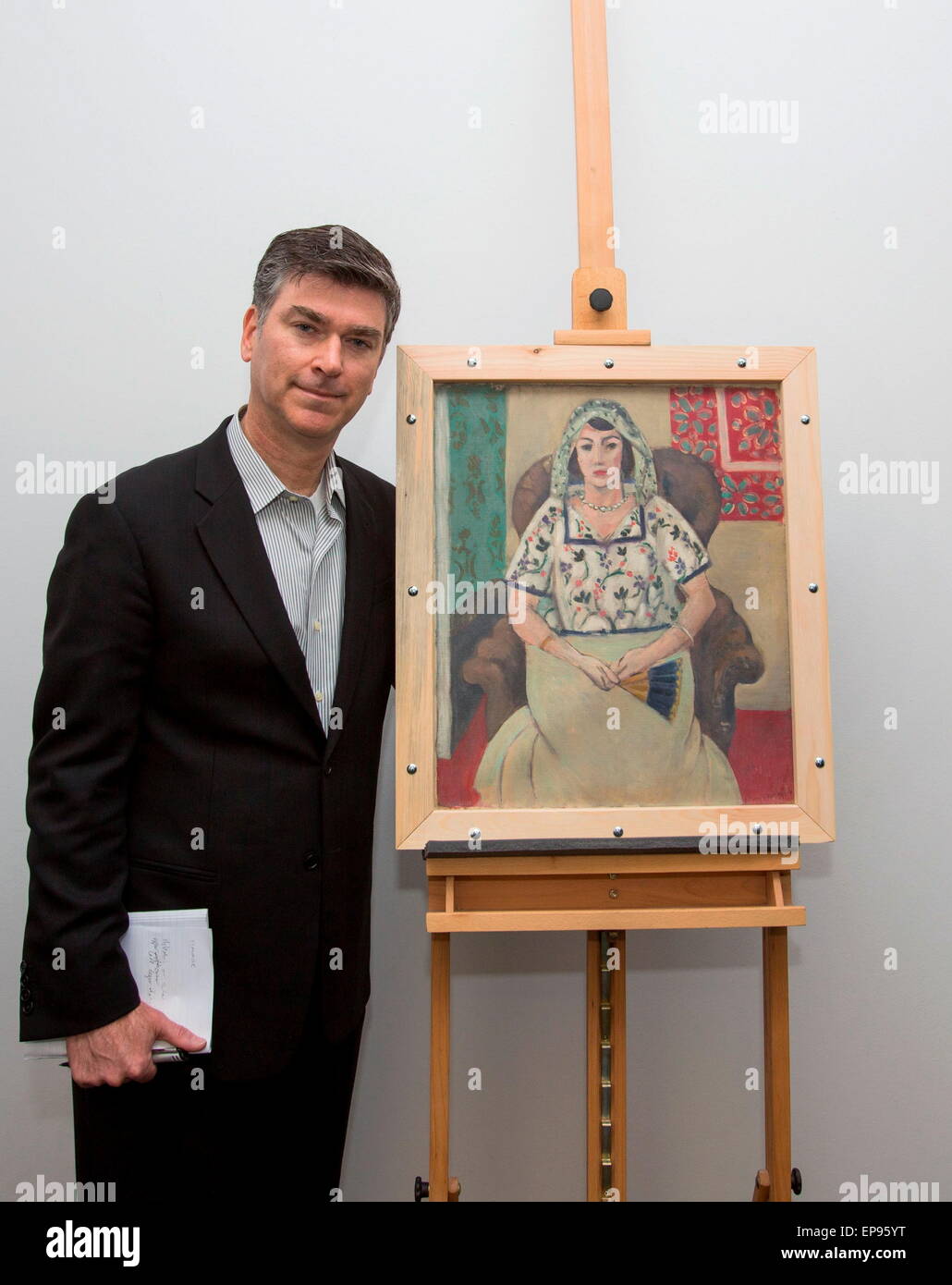 Christopher Marinello receives a Nazi-looted Henri Matisse painting Friday near Munich and will return it to the descendants of its rightful owner, Paul Rosenberg, after a German court ordered it this week. Woman Sitting in an Armchair was missing for decades until it was discovered in 2012 in a trove of 1,280 artworks worth more than a billion dollars in the Munich apartment of octogenarian recluse Cornelius Gurlitt, the son of a Nazi-era art dealer. DPA/WOLF HEIDER-SAWALL/ART RECOVERY GROUP HANDOUT Stock Photo