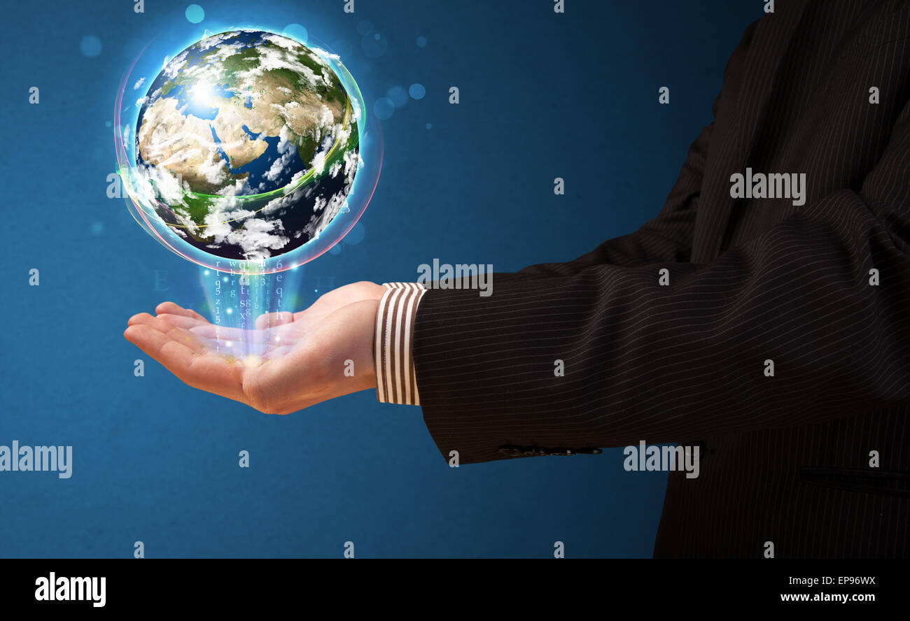 Businessman holding a glowing earth globe Stock Photo