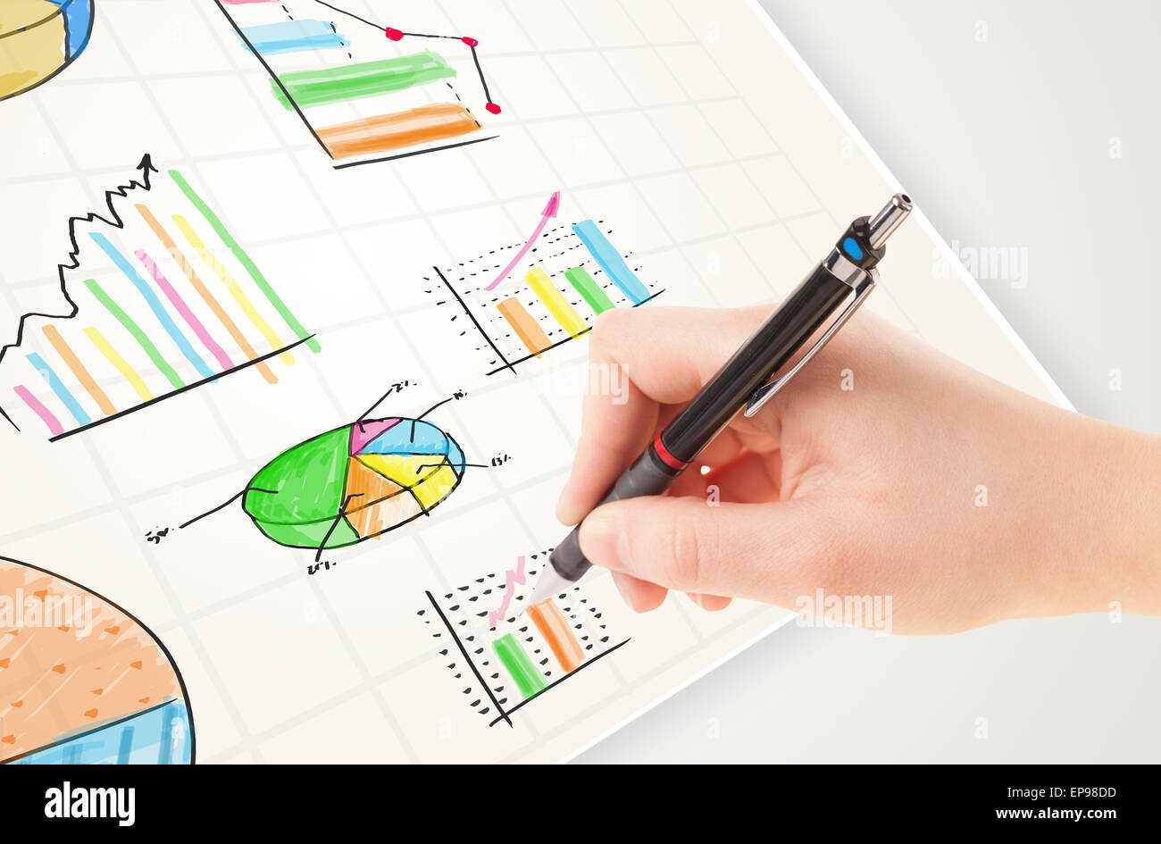 Business person drawing colorful graphs and icons on paper Stock Photo ...