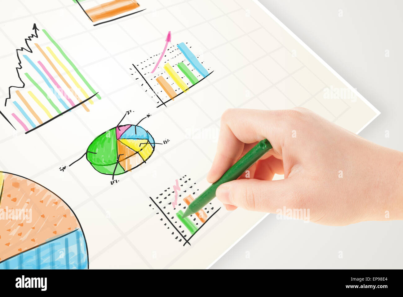 Business person drawing colorful graphs and icons on paper Stock Photo ...