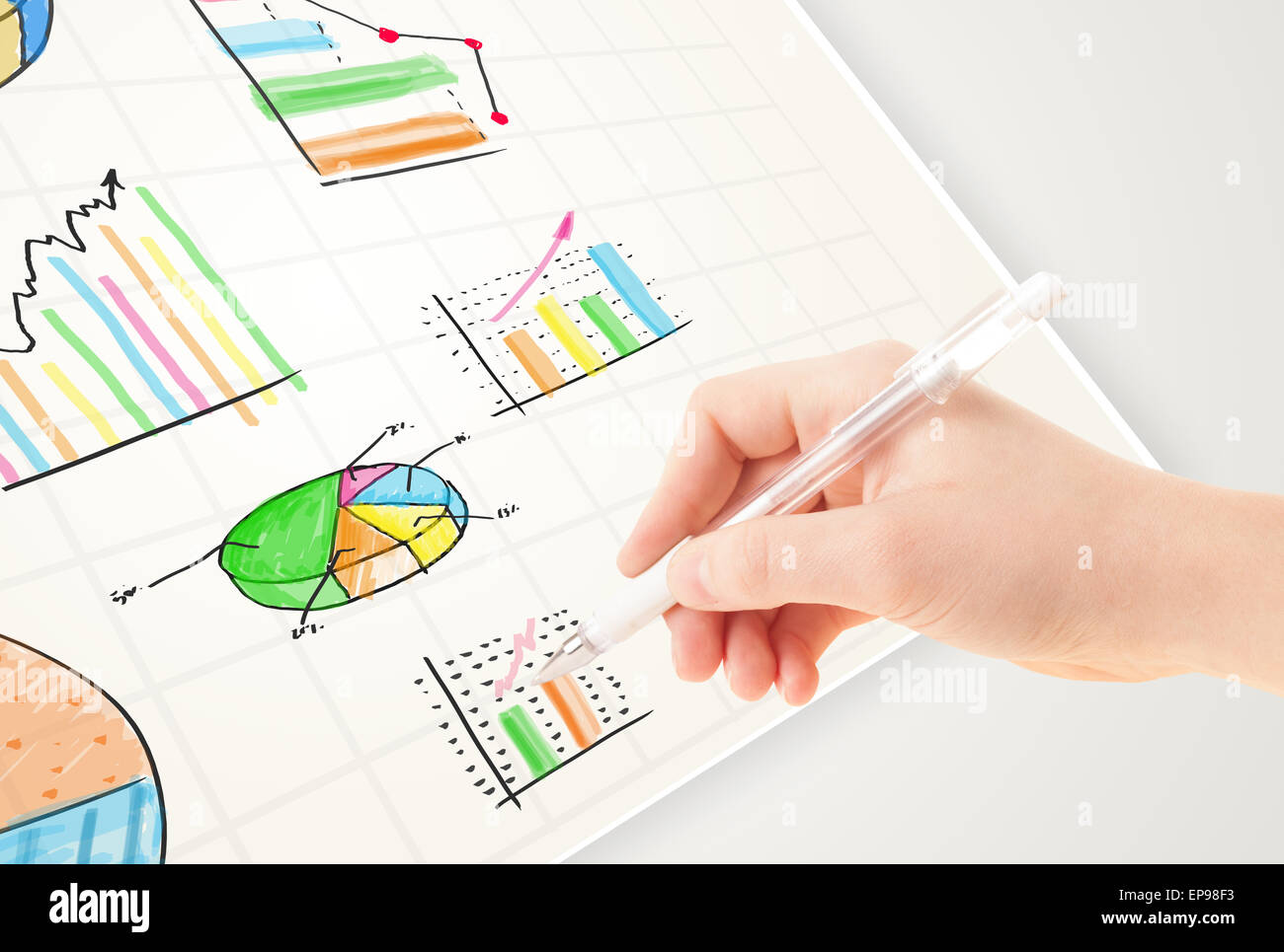 Business person drawing colorful graphs and icons on paper Stock Photo ...