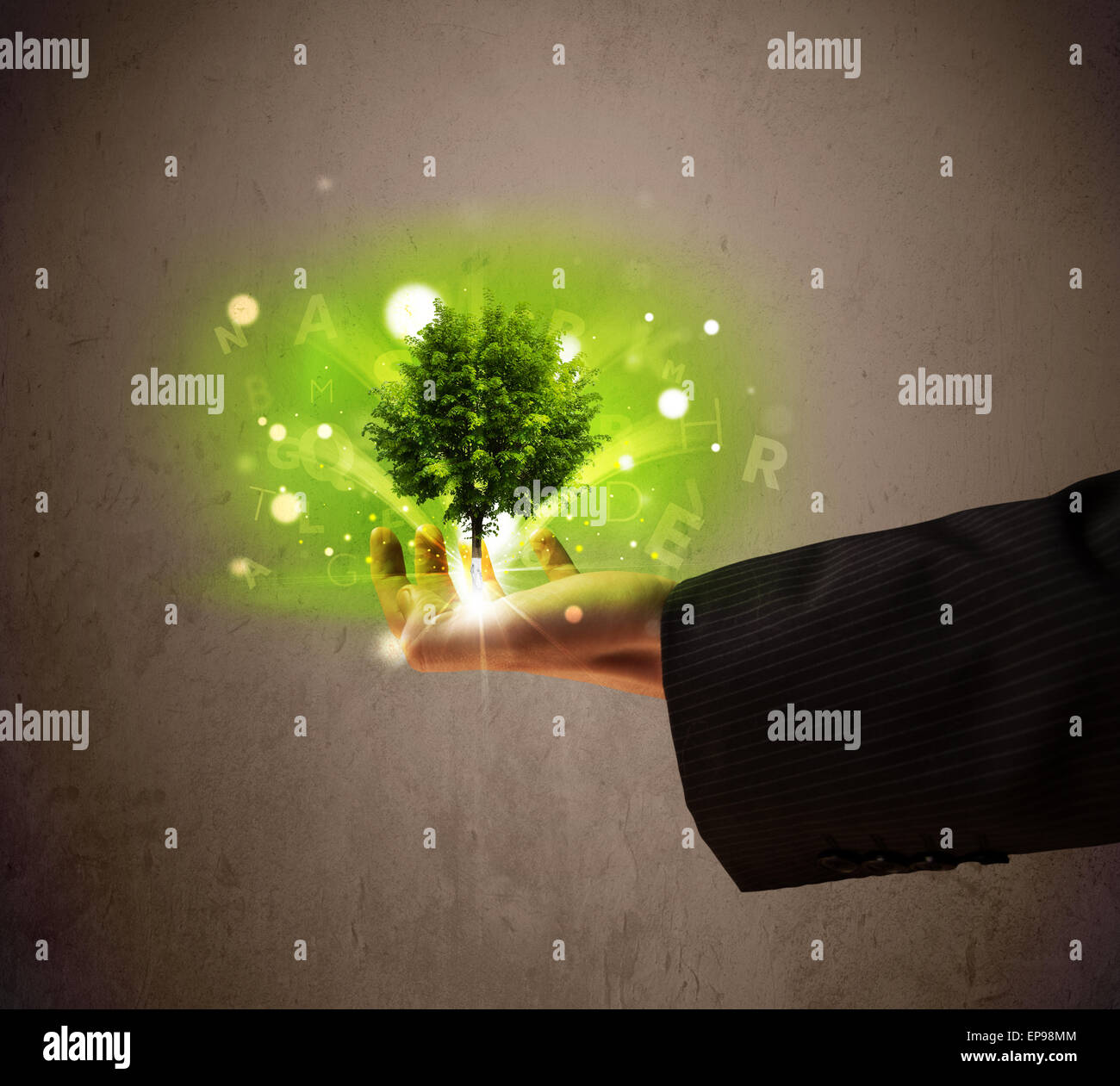 Glowing tree growing in the hand of a businessman Stock Photo - Alamy