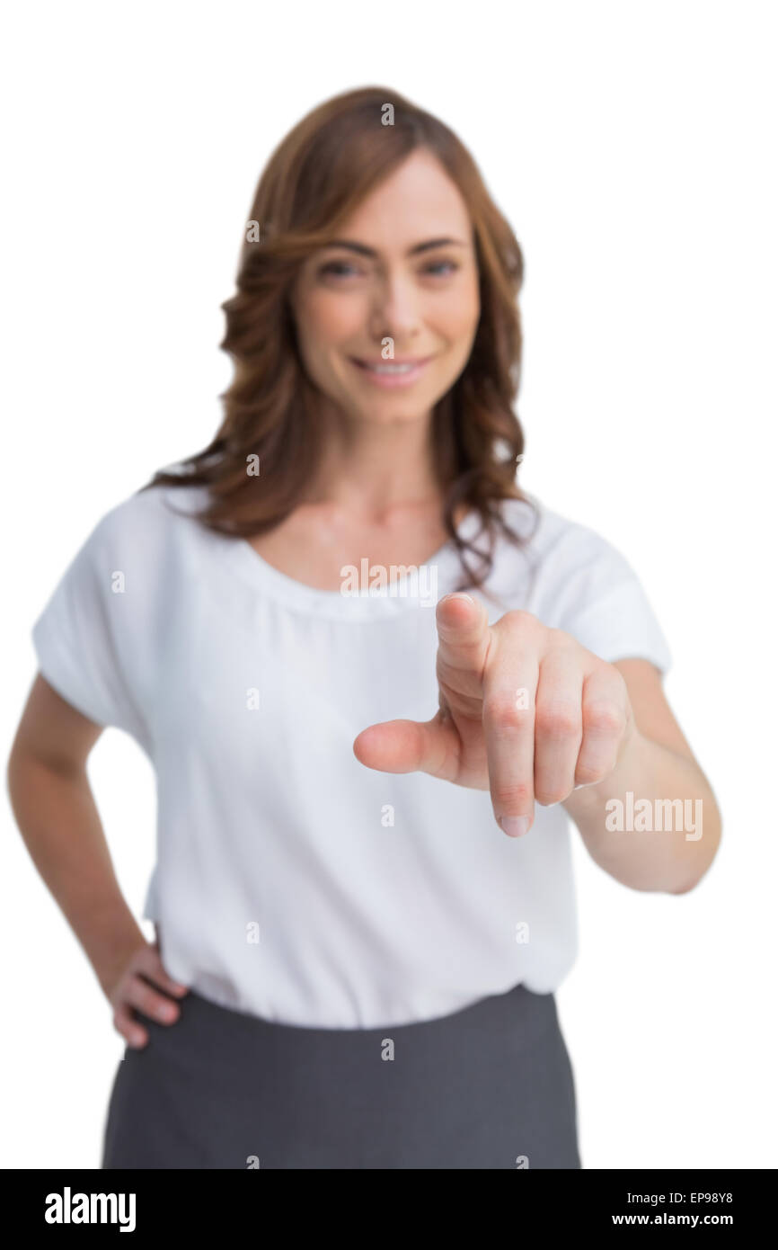 Attractive businesswoman looking and pointing at camera Stock Photo - Alamy