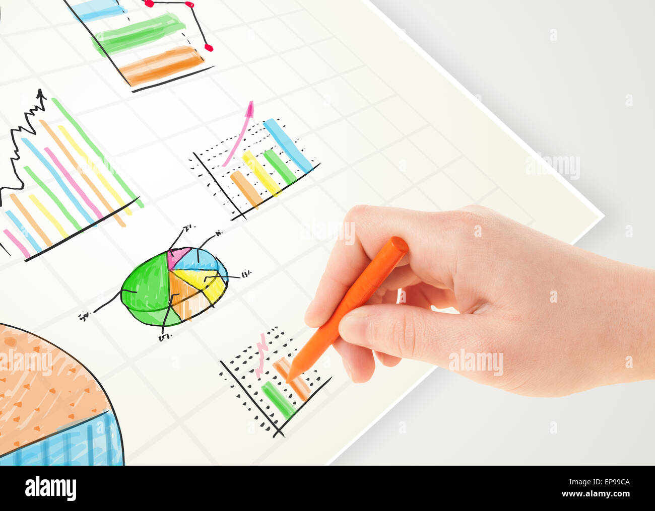 Business person drawing colorful graphs and icons on paper Stock Photo ...